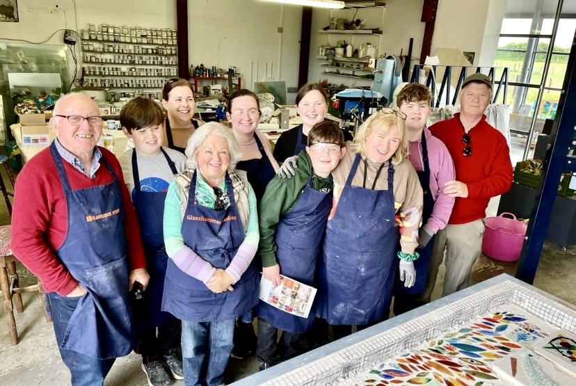 group of people standing with navy aprons